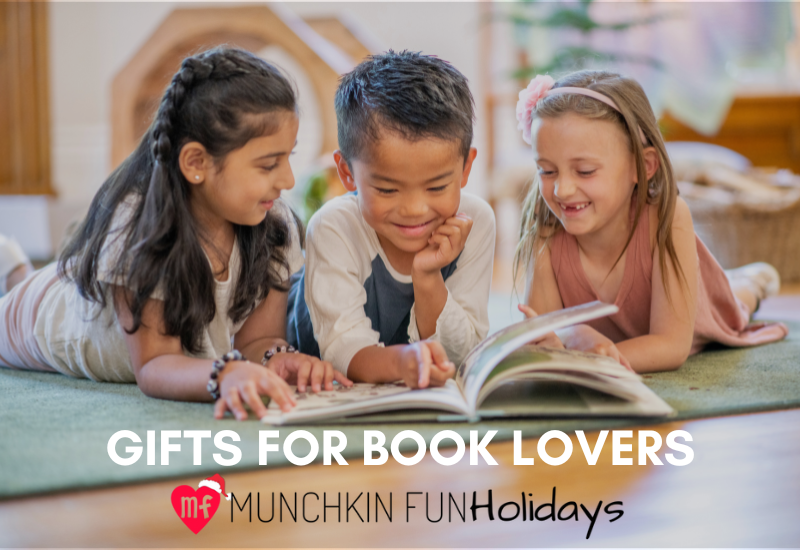 kids sitting on a blanket reading holiday books